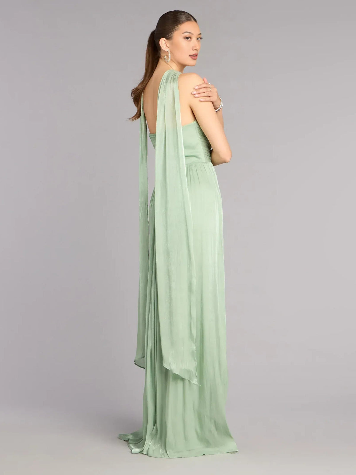 Sage green sleeveless prom dress with sweetheart front and open back drape, pleated hem