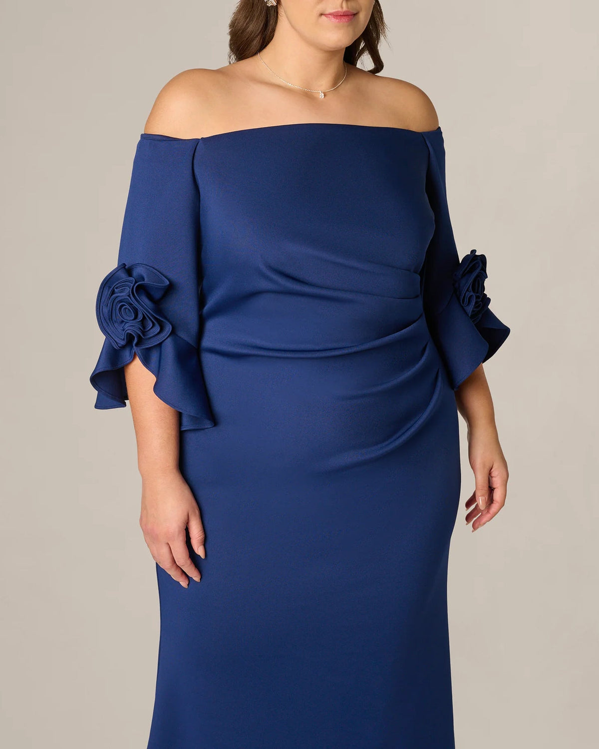 Off-shoulder navy A-line maxi dress, close-up of draped bodice and rosette sleeves