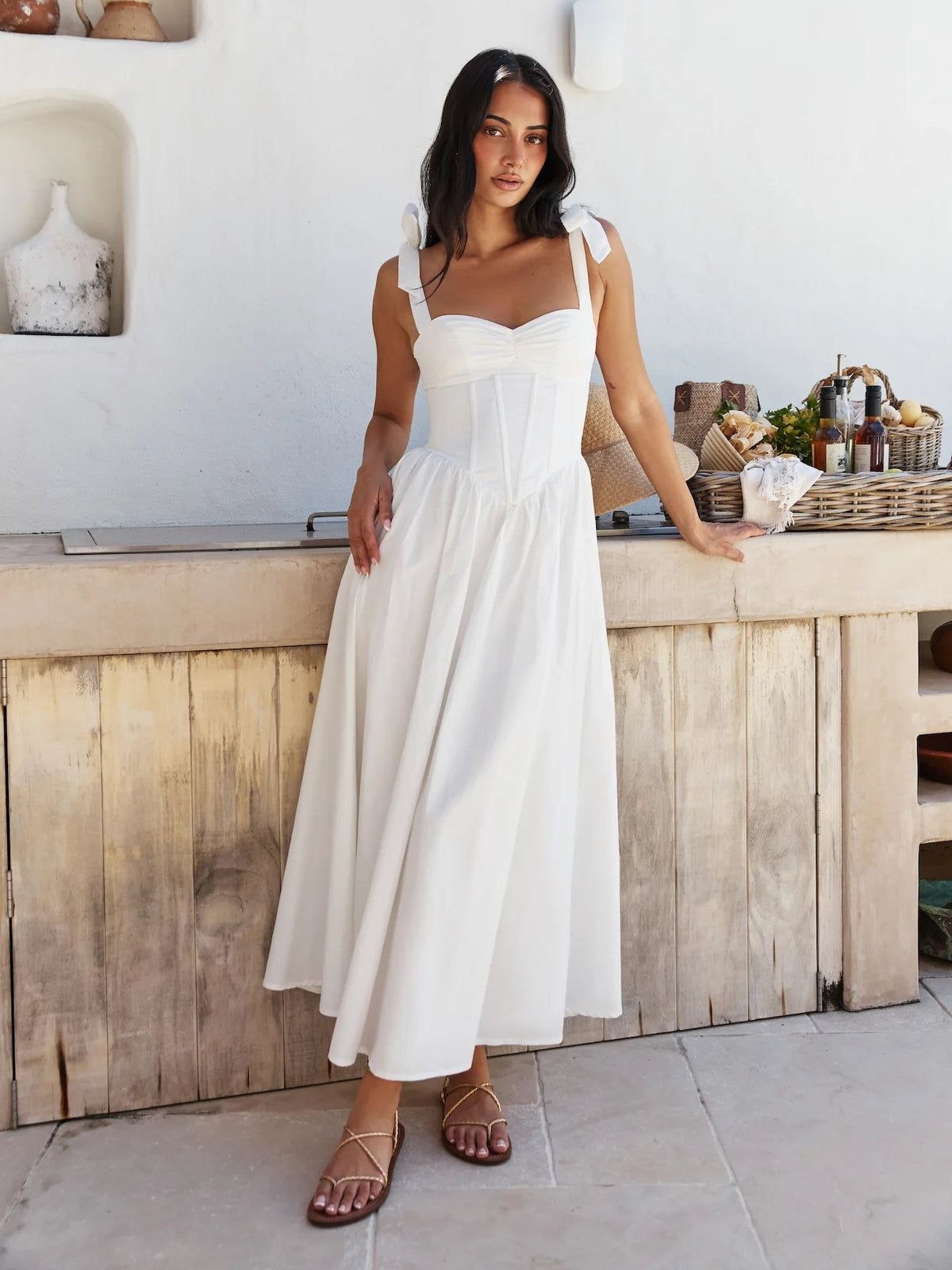 White midi formal dress with square neckline, bow shoulder straps, and flared gathered skirt.