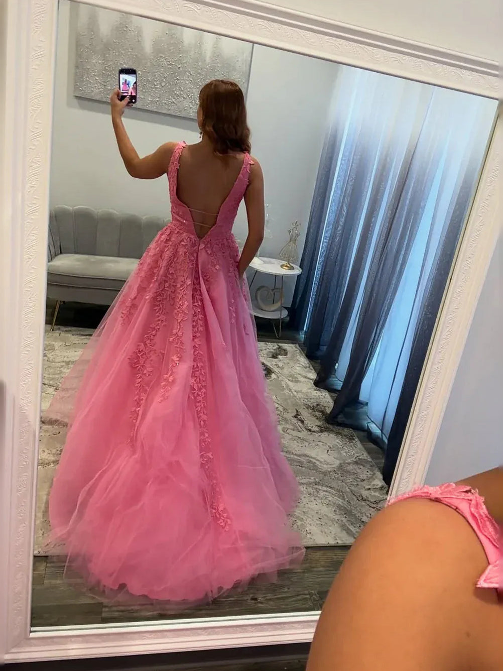 Pink A-line tulle prom dress shown from back view, lace V-back and full skirt