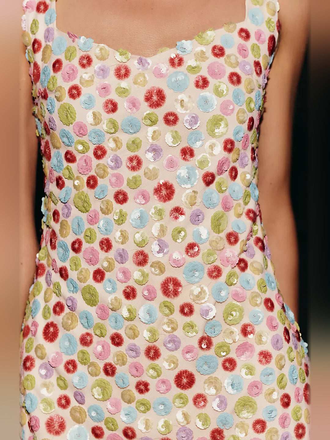 Close-up of multicolor dotted pattern on sleeveless mini dress bodice