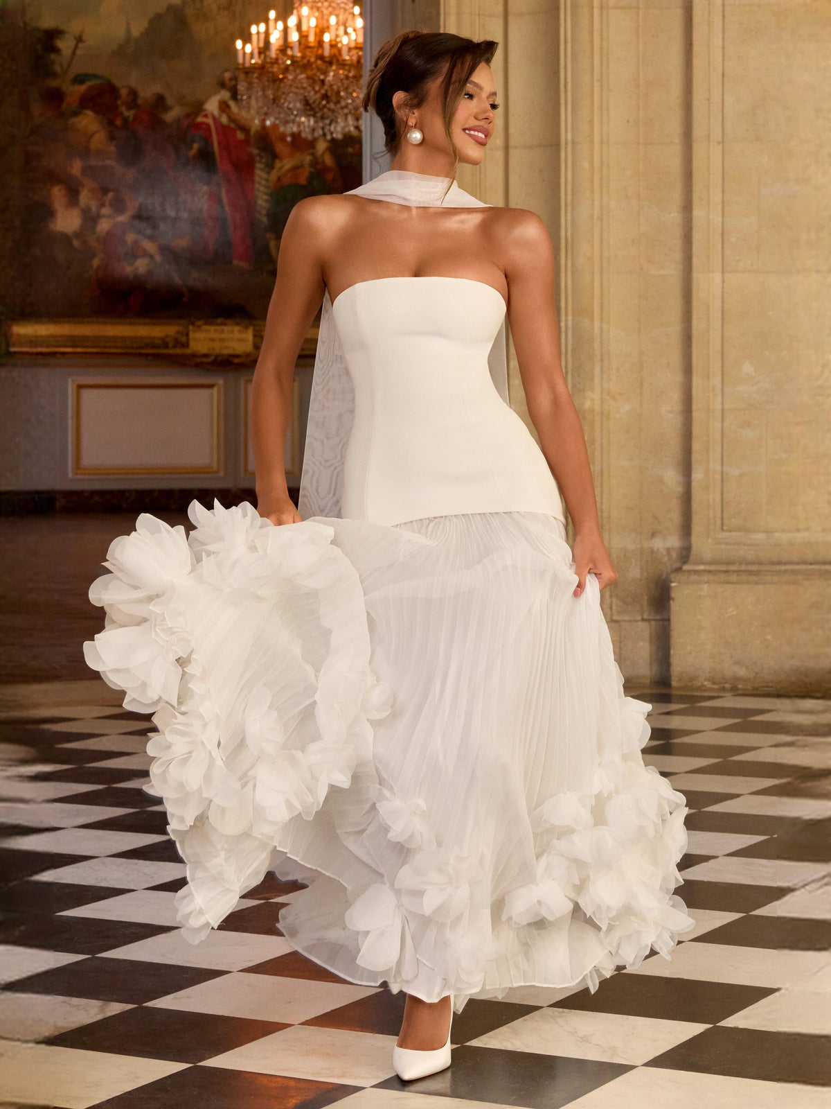 Ivory strapless wedding dress with corset bodice and voluminous layered floral ruffle hem