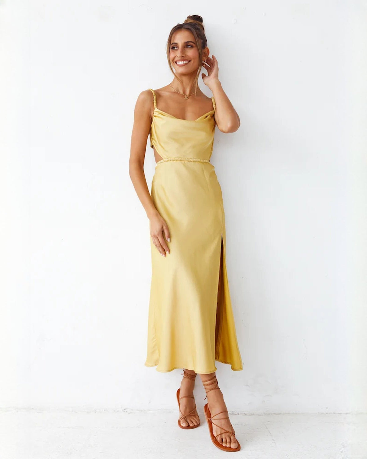 Yellow satin A-line maxi bridesmaid dress with thin straps and front leg slit
