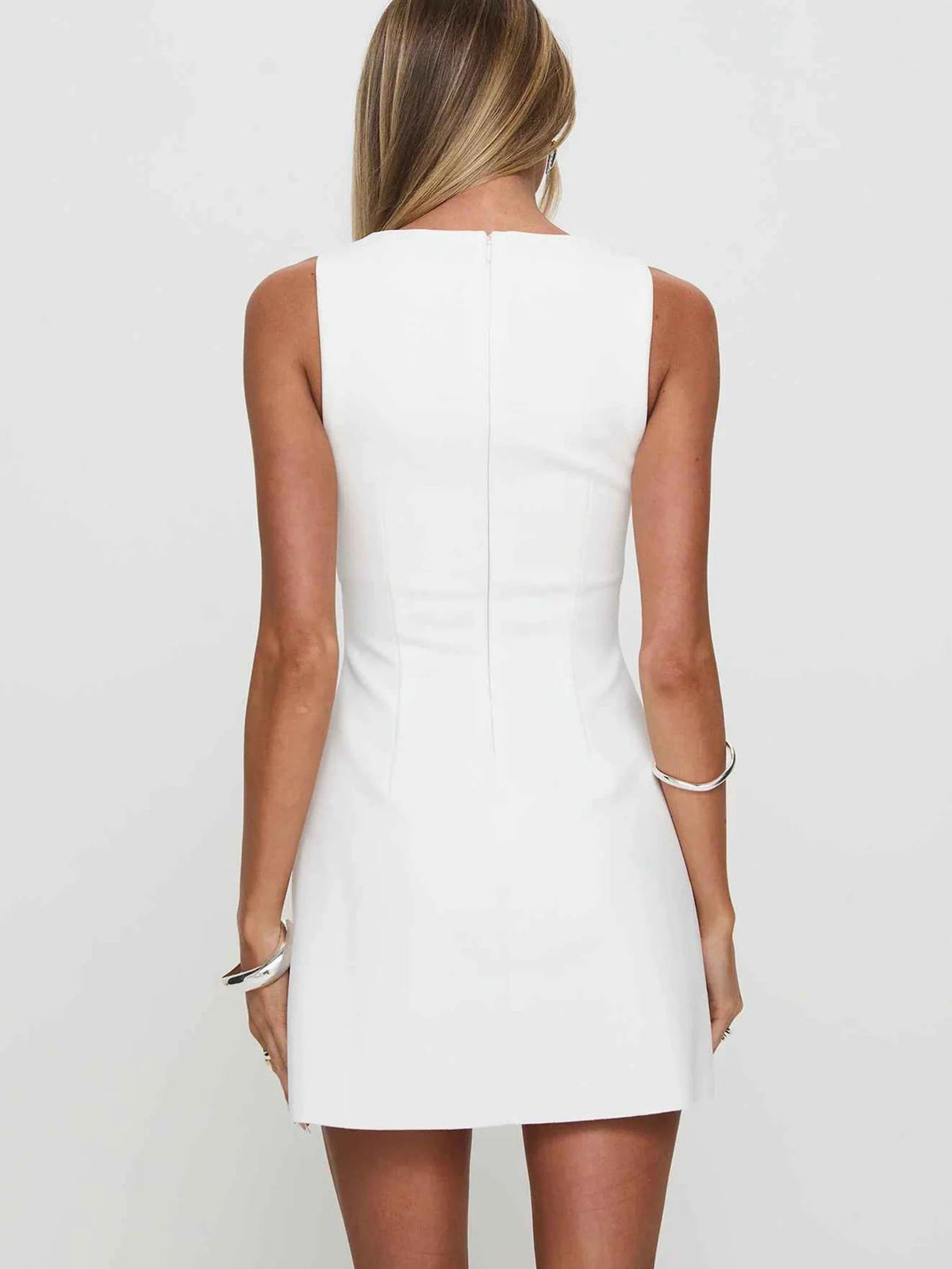 Ivory sleeveless A-line mini dress, back view with vertical seam detailing