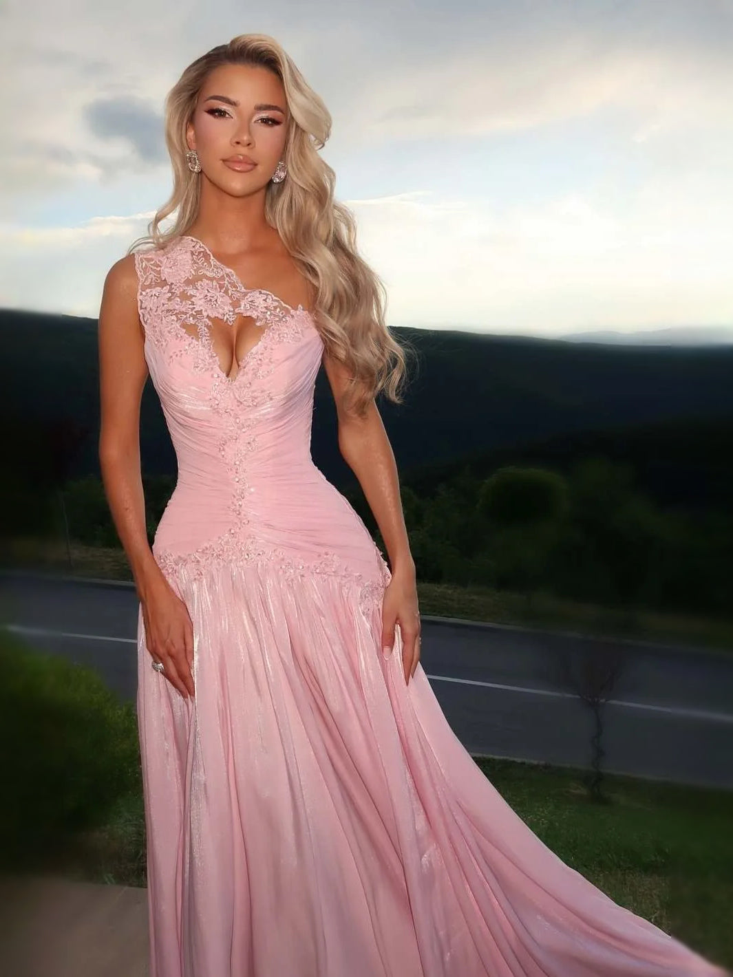 Pink one-shoulder prom dress with floral lace bodice, ruched waist, flowing A-line skirt