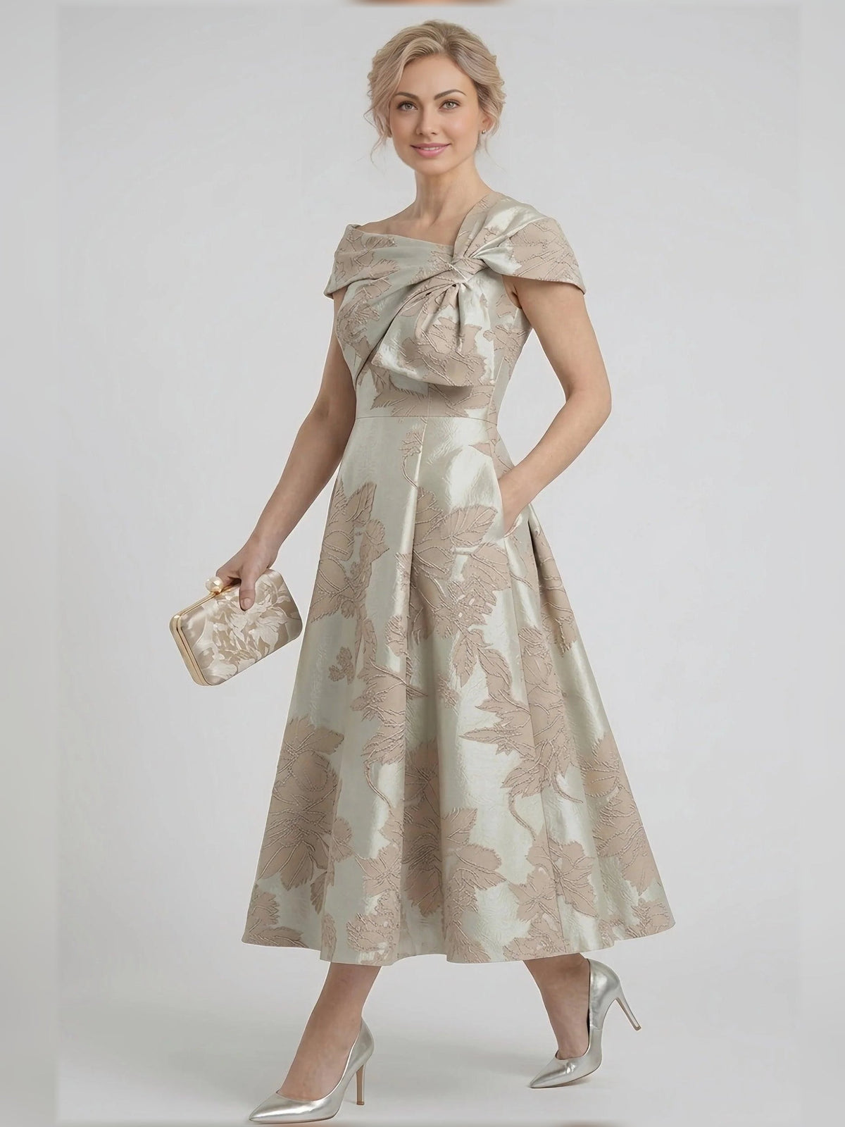 Champagne floral A-line tea-length dress with draped bow and cap sleeves, side view