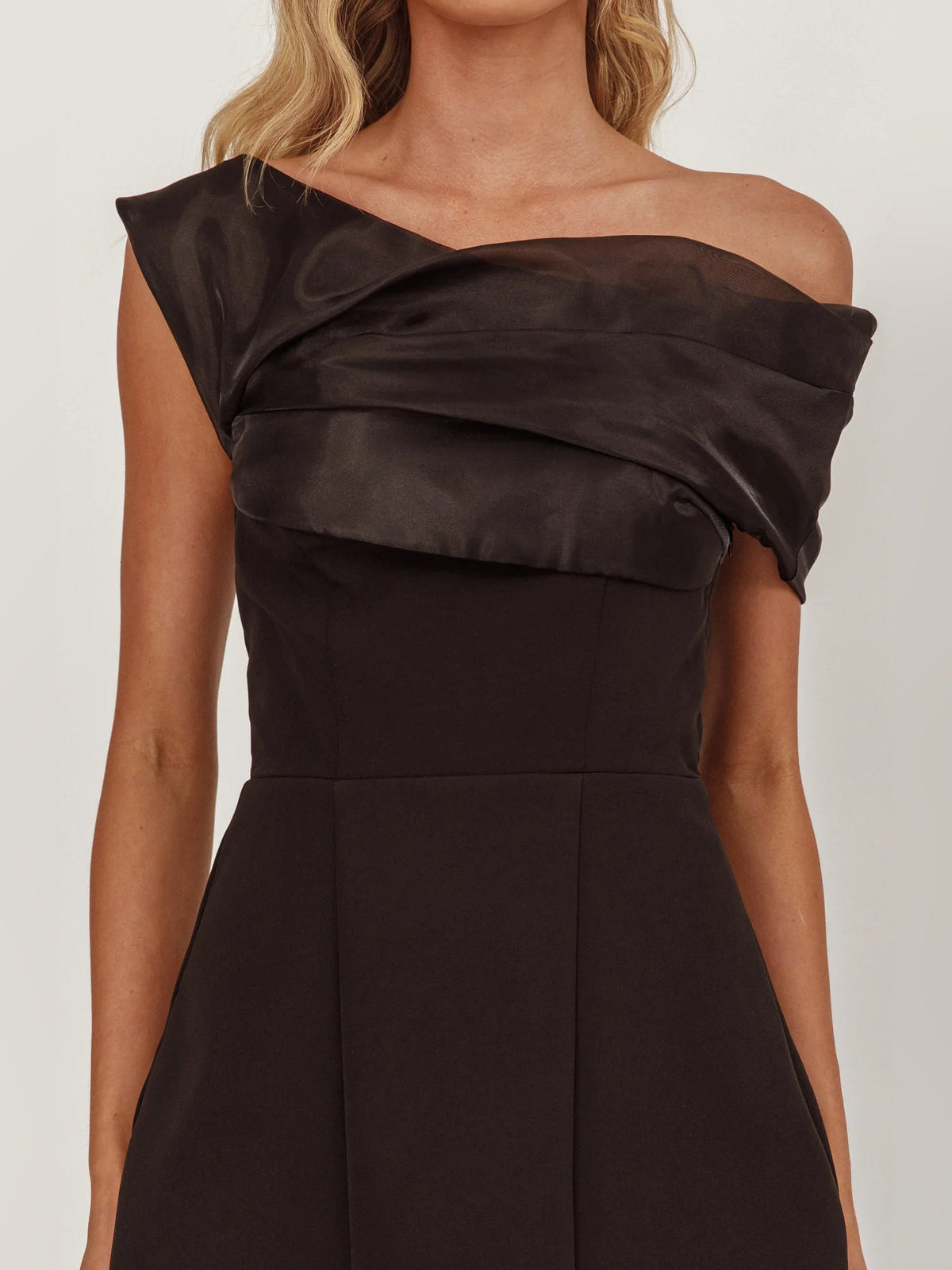 Black off-shoulder bodice with layered fabric drape across neckline