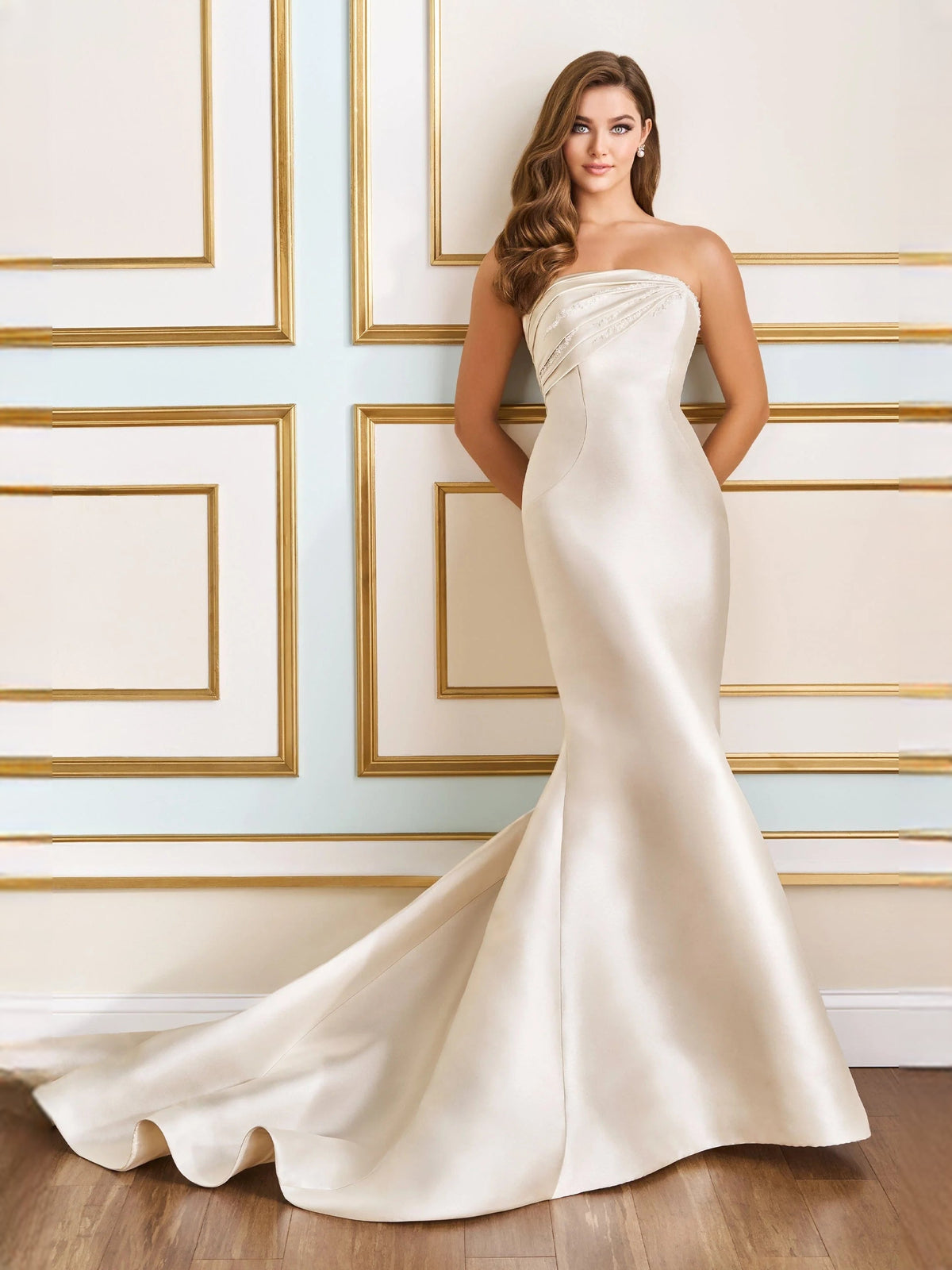 Ivory strapless satin mermaid-like wedding dress with ruched draped bodice and sweep train