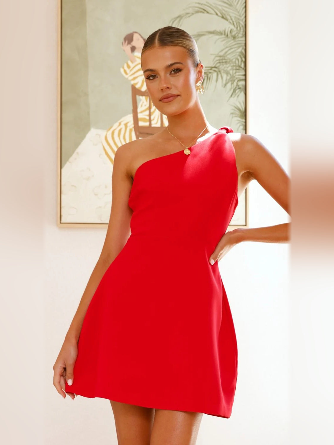 Red one-shoulder mini dress with draped neckline and smooth fitted bodice