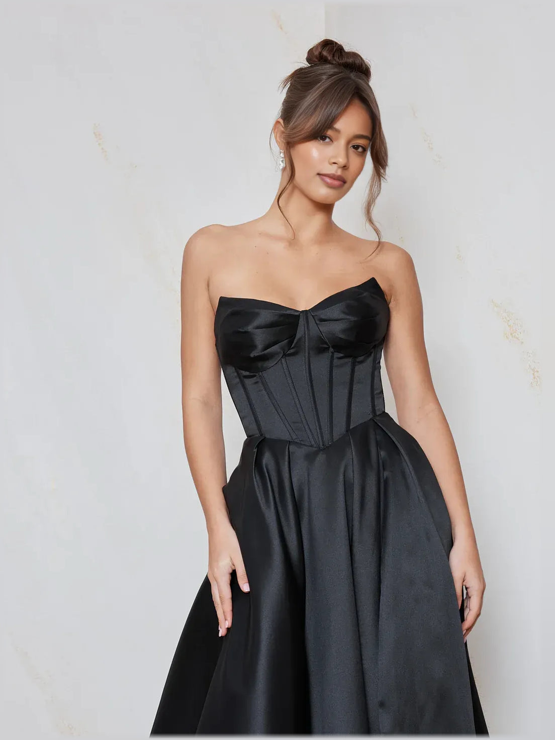 Black strapless sweetheart corset bodice with gathered full floor-length satin skirt