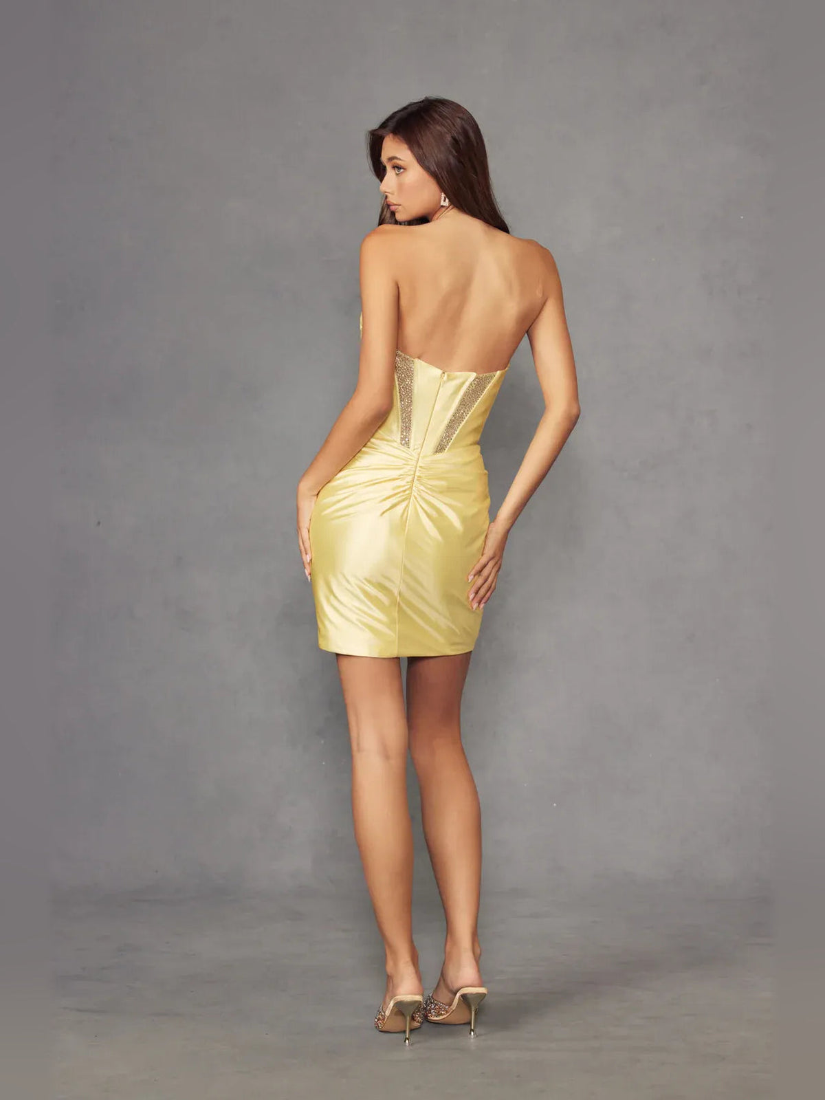 Back view of pale lemon satin sheath mini dress with gathered corset detail