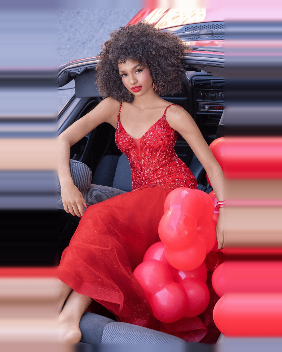 Red beaded corset mermaid dress with plunging V neckline and flowing tulle hem