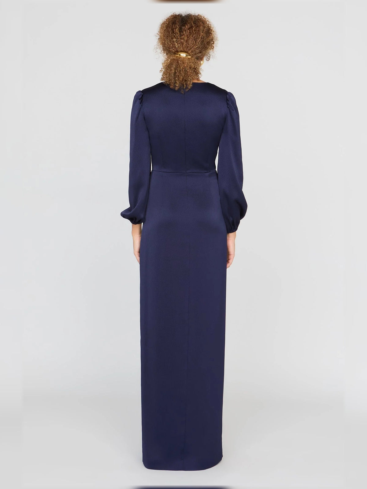 Dark navy satin column gown with long sleeves and draped waist bow, back view