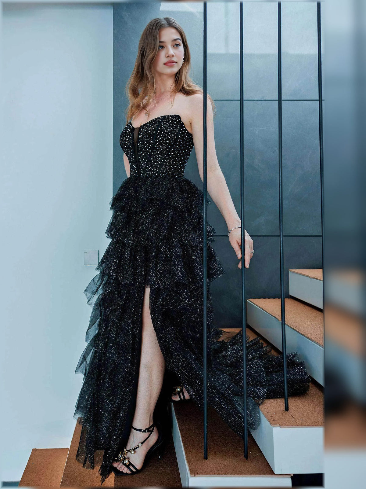 Black strapless tiered ruffle gown with side slit and corset-style bodice