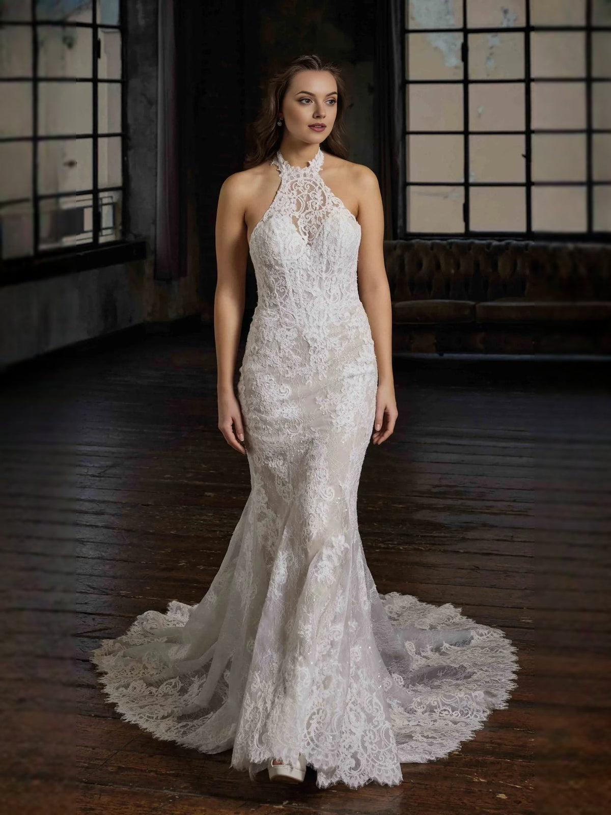 Ivory halter-neck mermaid wedding dress with floral lace appliques and trailing tulle