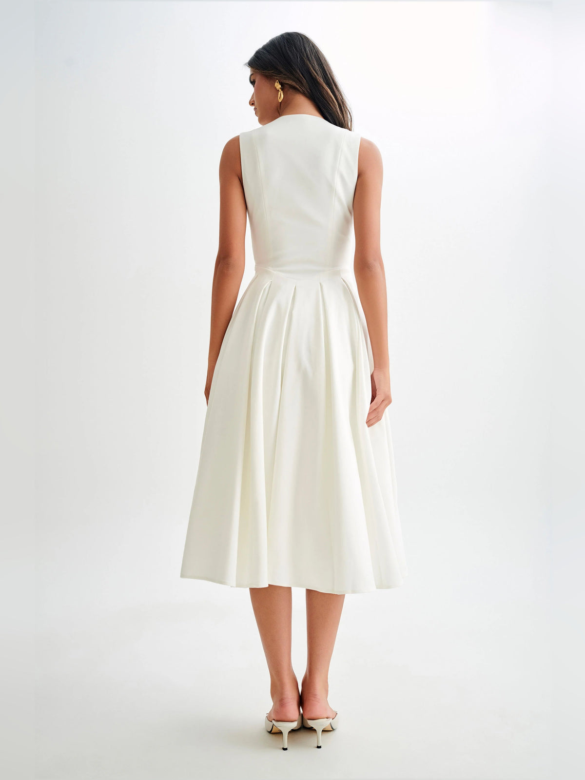 White sleeveless midi dress with V-neck front and gathered pleated skirt, back view
