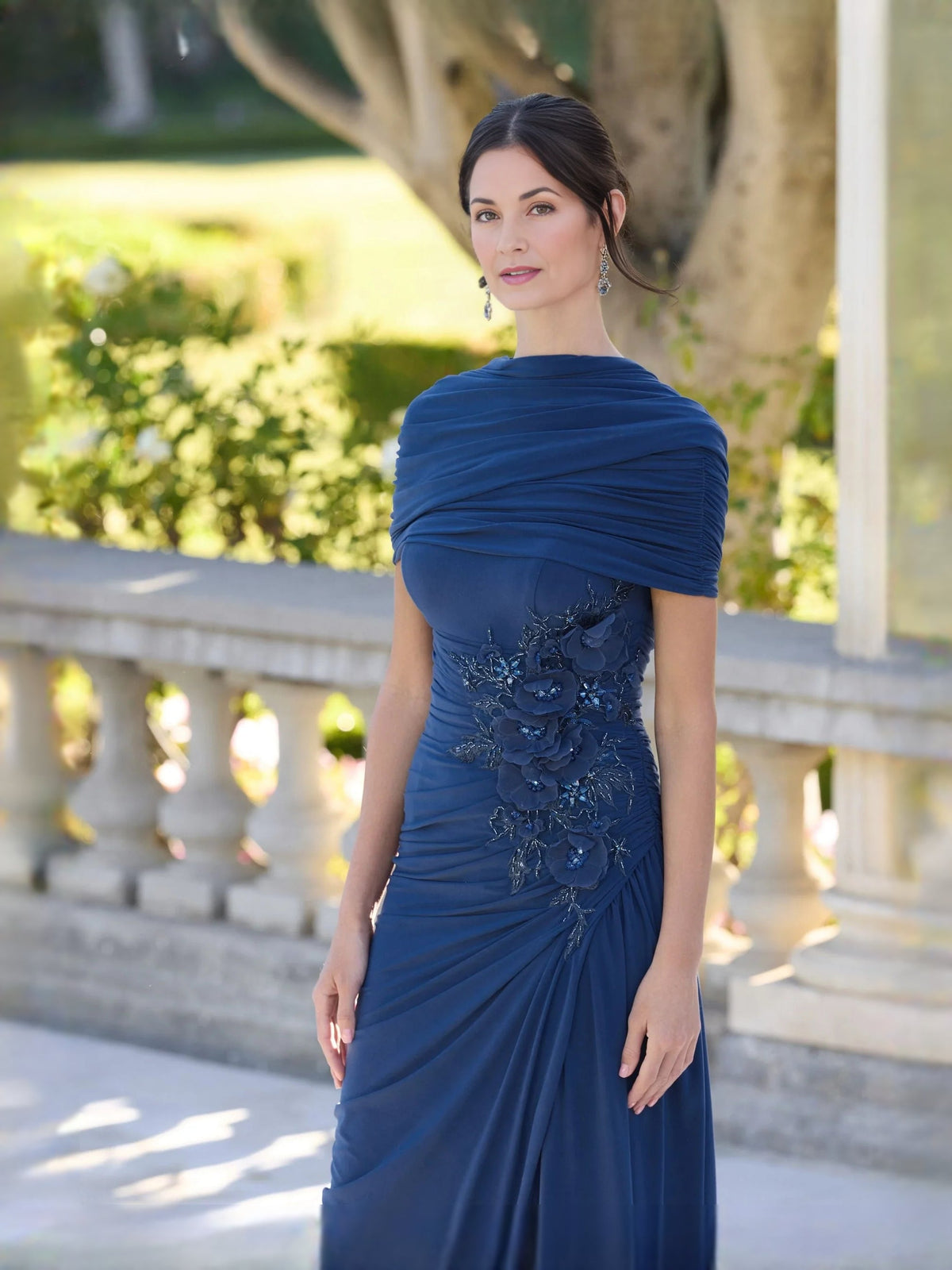 Dark blue ruched jersey mermaid dress with V-neck and large floral applique at back