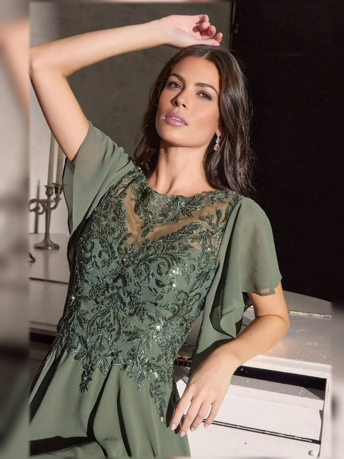 Dusty sage chiffon gown with ornate beaded neckline and draped flutter sleeve overlay