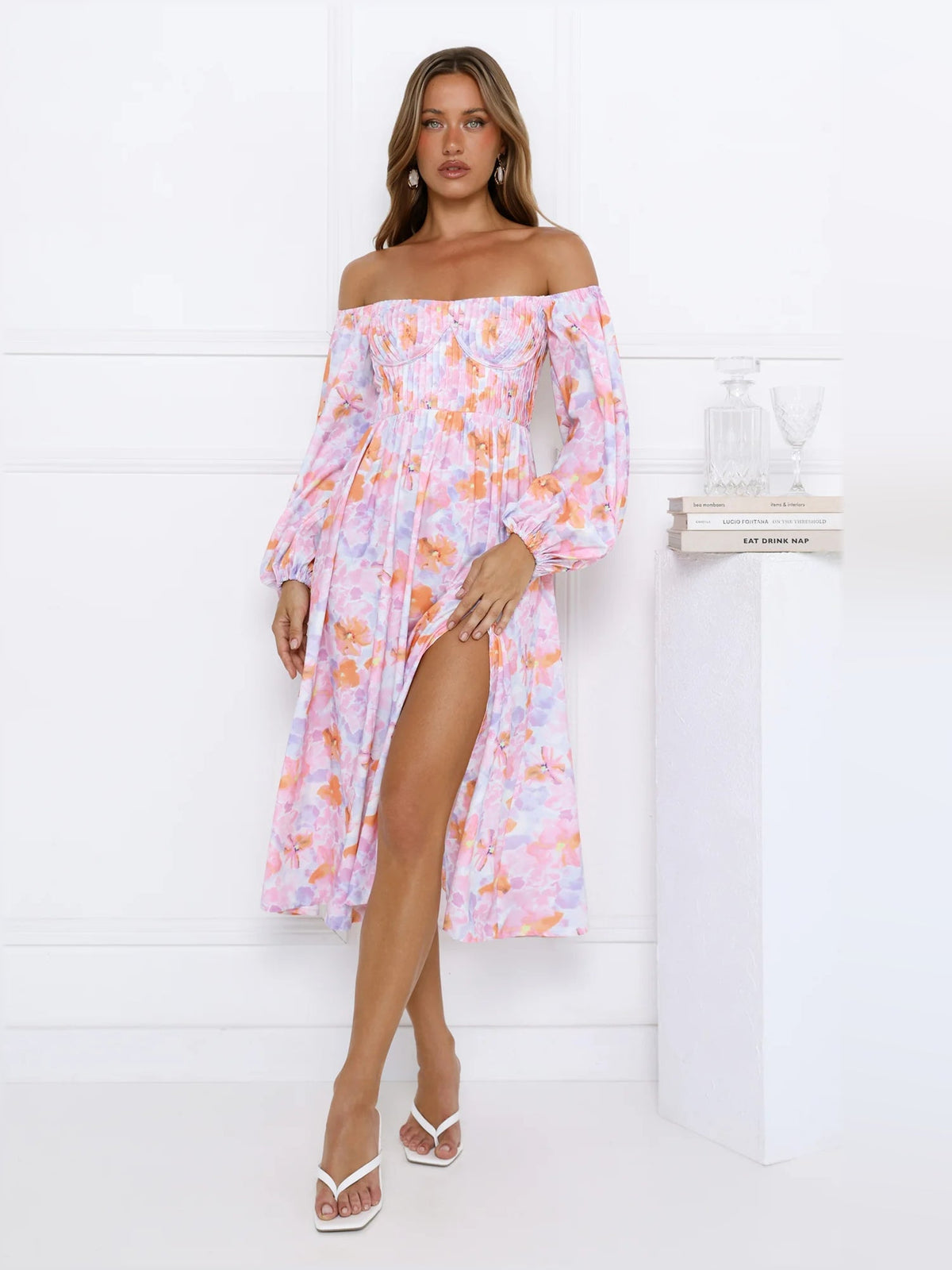 Floral off-shoulder midi dress with gathered neckline and long puff sleeves.