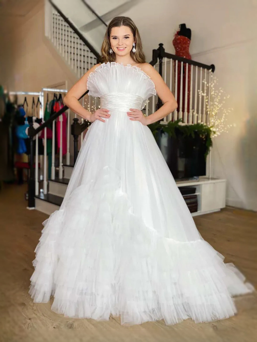 White strapless sweetheart maxi dress with ruched bodice and tiered ruffle tulle skirt.