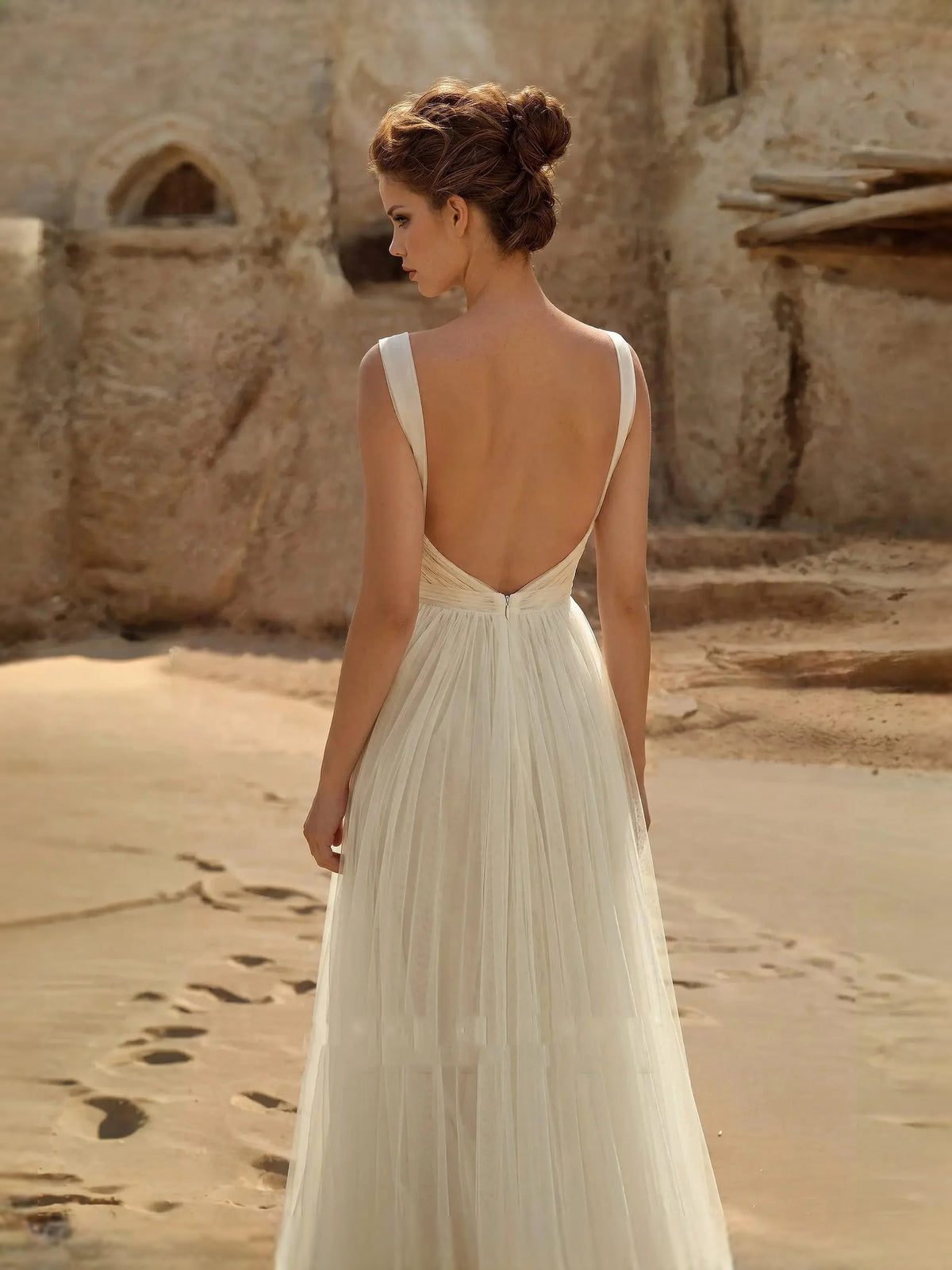 Ivory chiffon A-line wedding dress, ruched backless bodice with flowing pleated skirt
