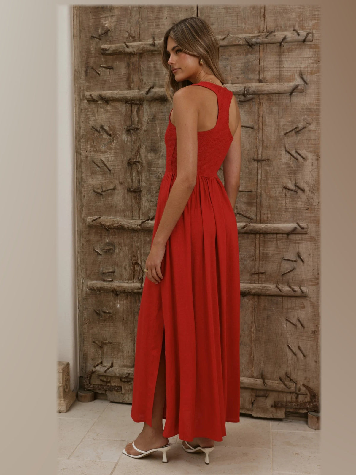 Red formal dress with structured woven fabric construction and maxi hem
