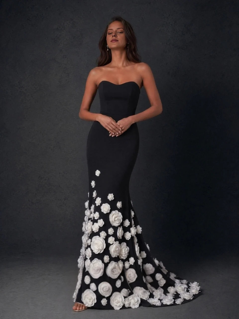 Black sweetheart strapless gown with white rose appliques and flared floor-length skirt