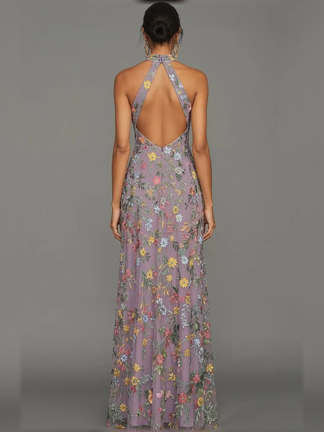 Back view of lilac floral halter neck formal dress with open back and slit