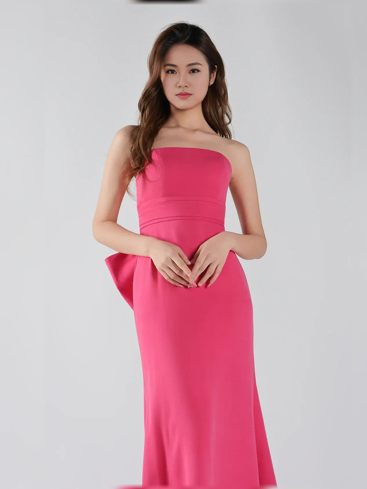 Hot pink strapless mermaid formal dress with ruched waist and fitted skirt