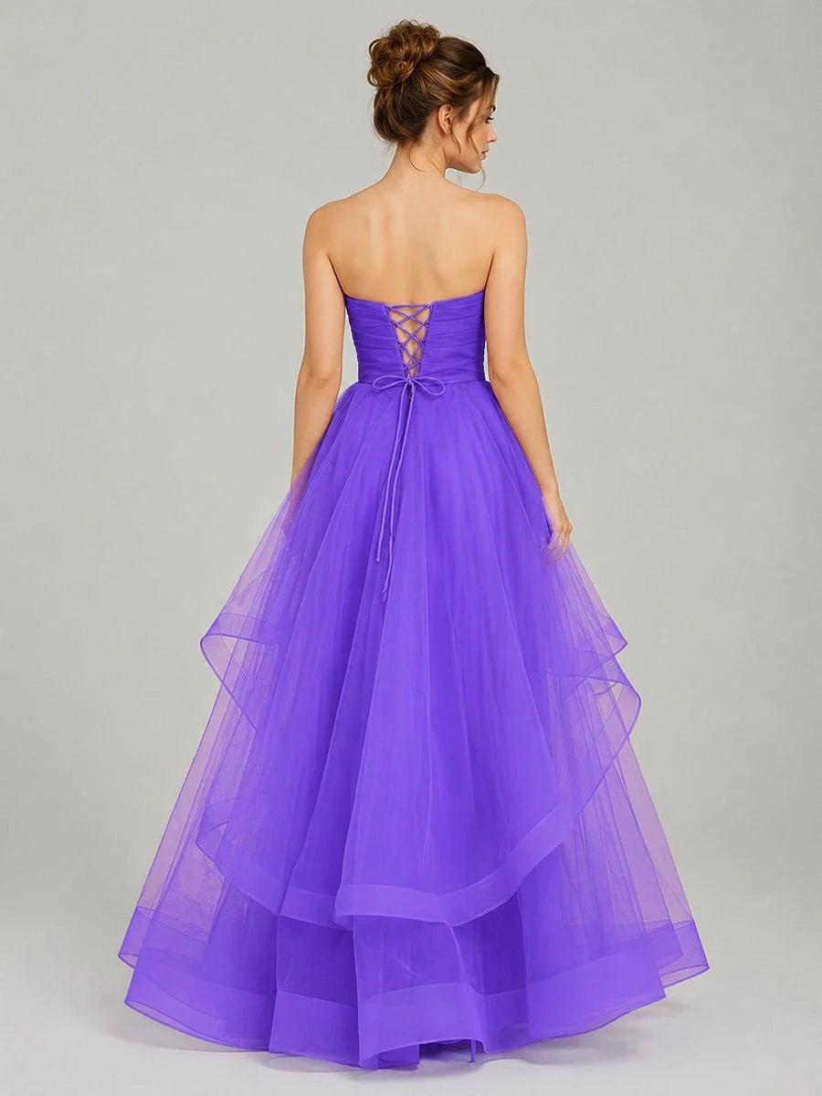 Purple strapless tulle prom dress with ruched bodice and layered ballgown skirt, open back