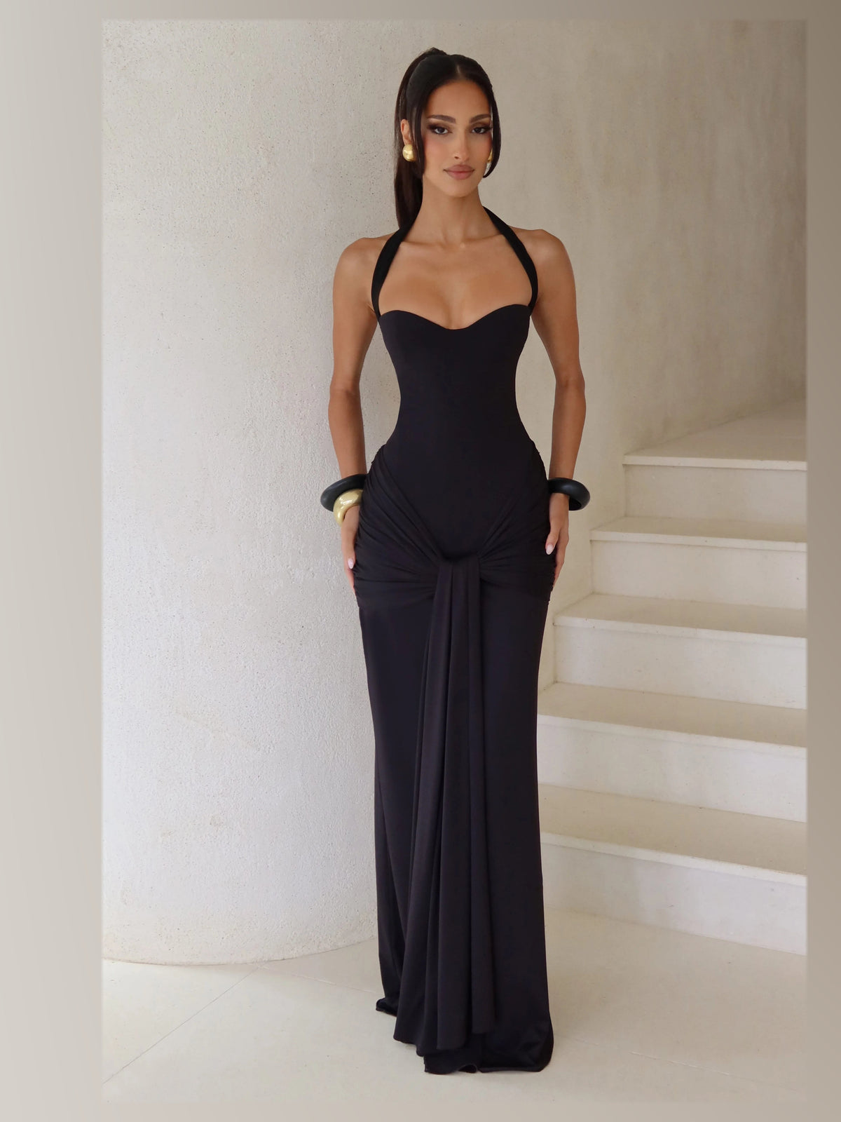 Black formal dress with structured woven fabric construction and maxi hem