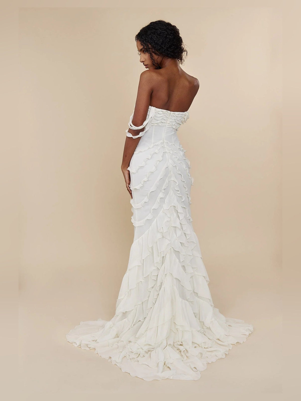 Ivory sweetheart prom dress with layered ruffles and side slit, back view