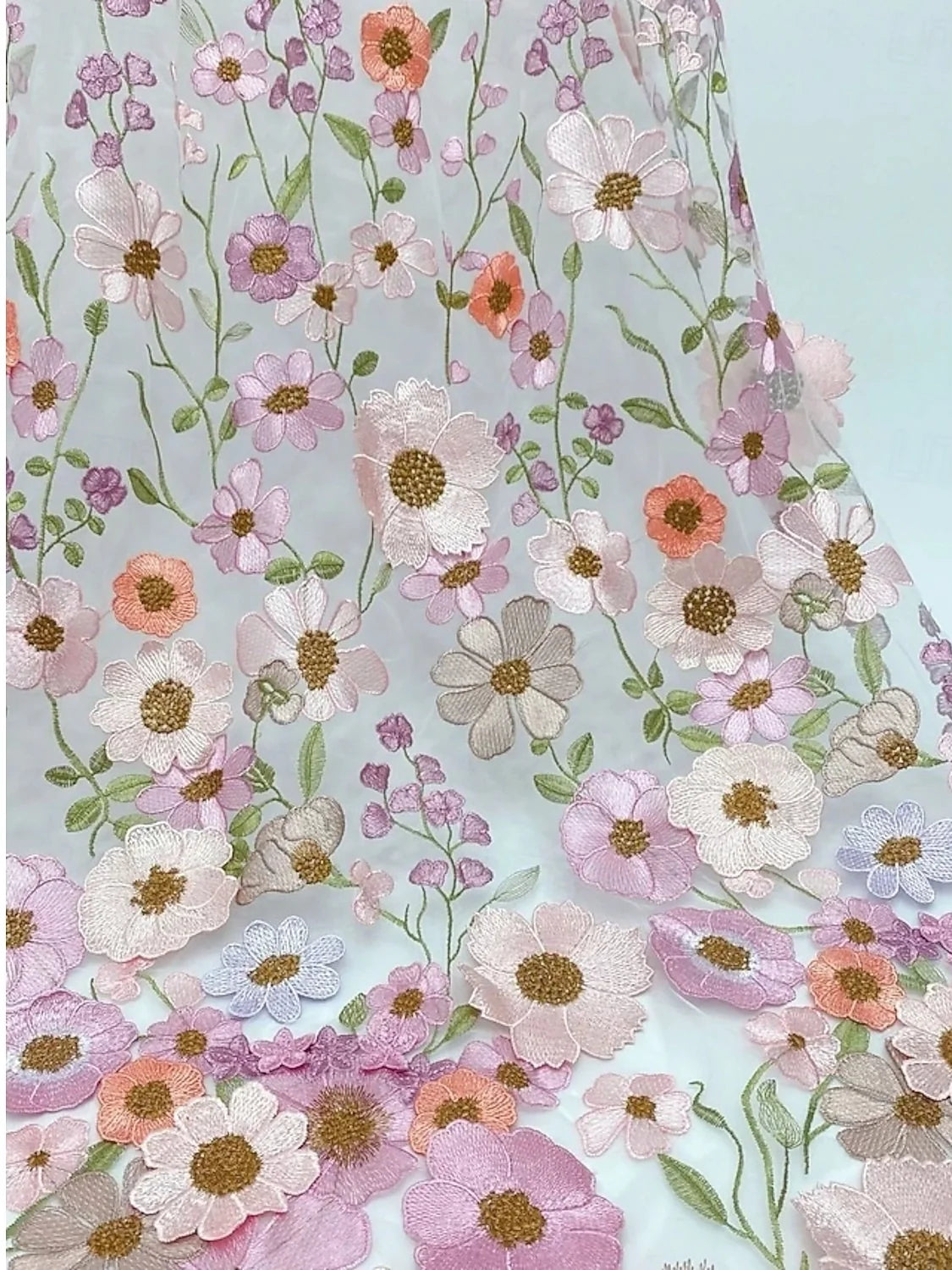Floral embroidered overlay fabric detail on a blush pink A-line maxi dress