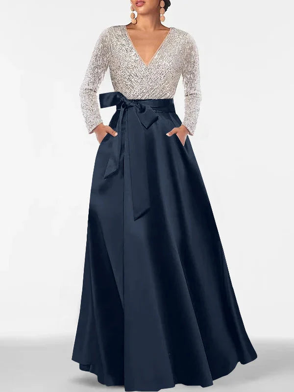 V-neck formal dress with silver sequin long sleeves, dark navy satin skirt and waist tie