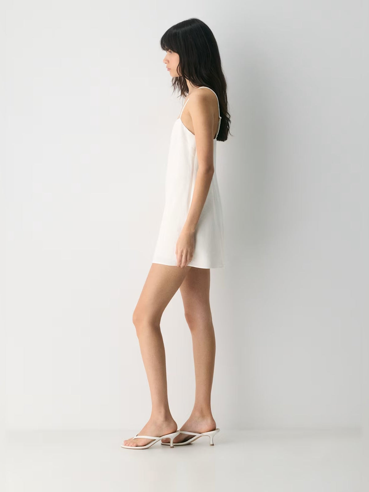 White square-neck mini dress with spaghetti straps, side view