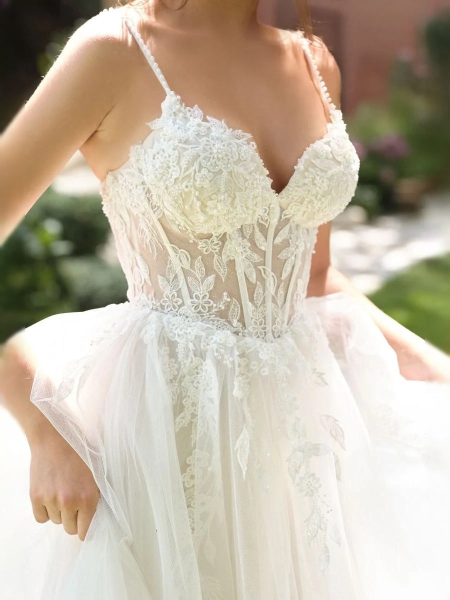 Ivory lace corset bodice with floral embroidery and thin straps, layered tulle skirt