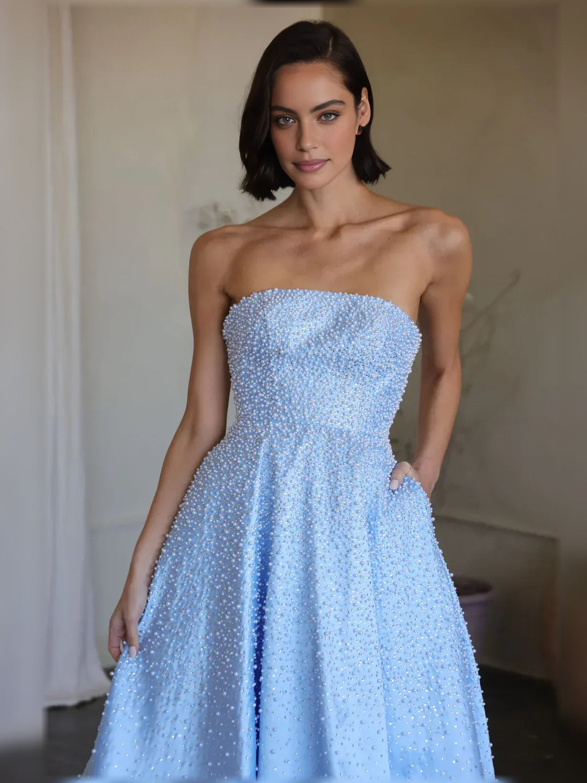 Light blue strapless beaded corset bodice and gathered full skirt, close-up view.