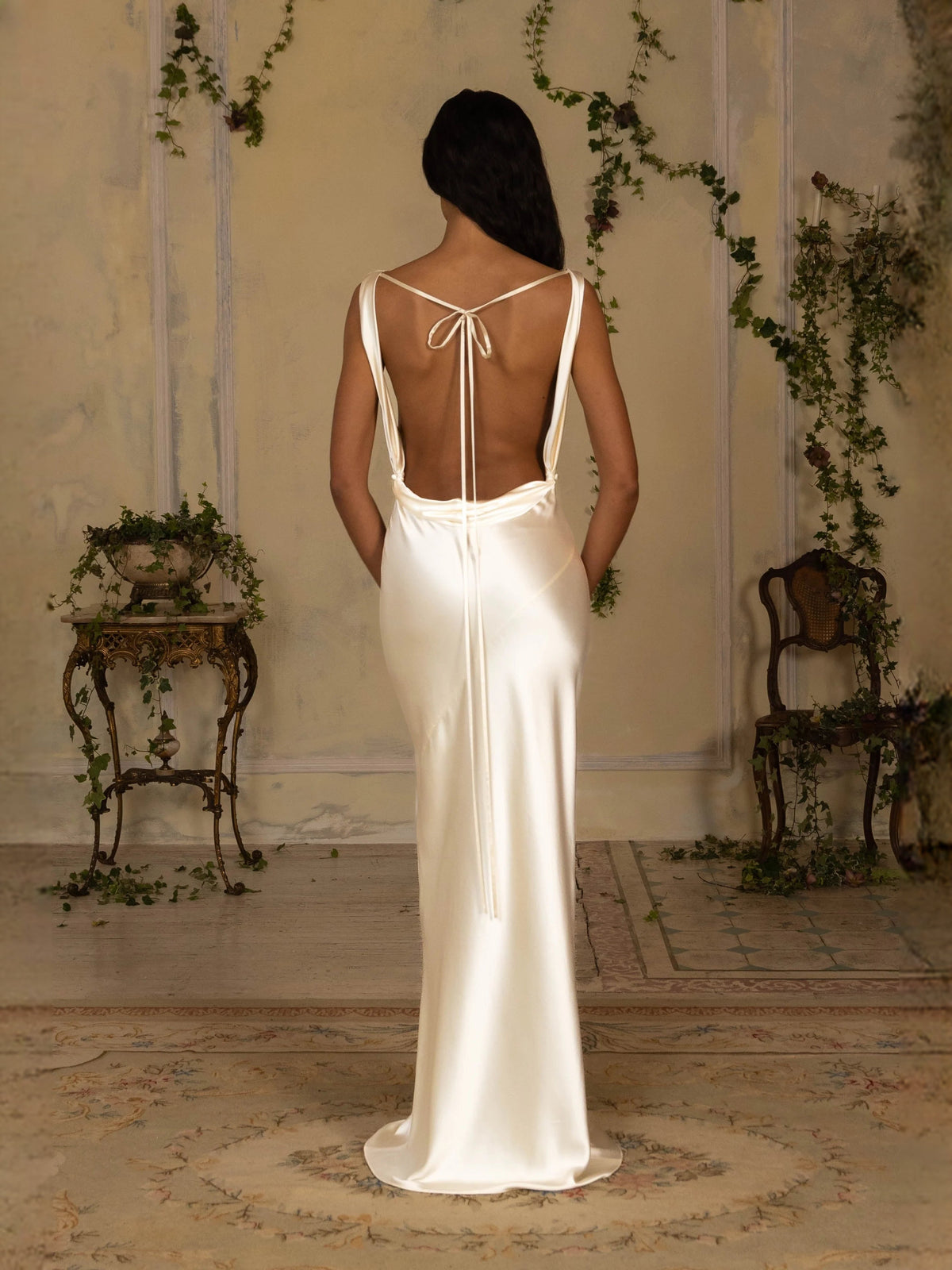 Ivory satin cowl-neck sheath prom dress, back view with tied bow and open straps
