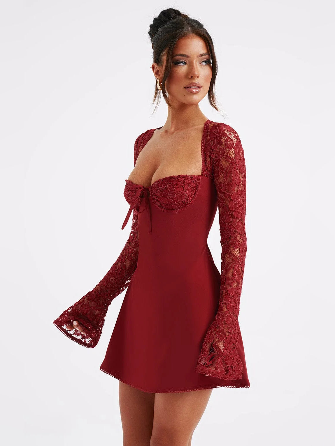 Red mini dress with sweetheart neckline, long lace sleeves, and bow-tie bodice