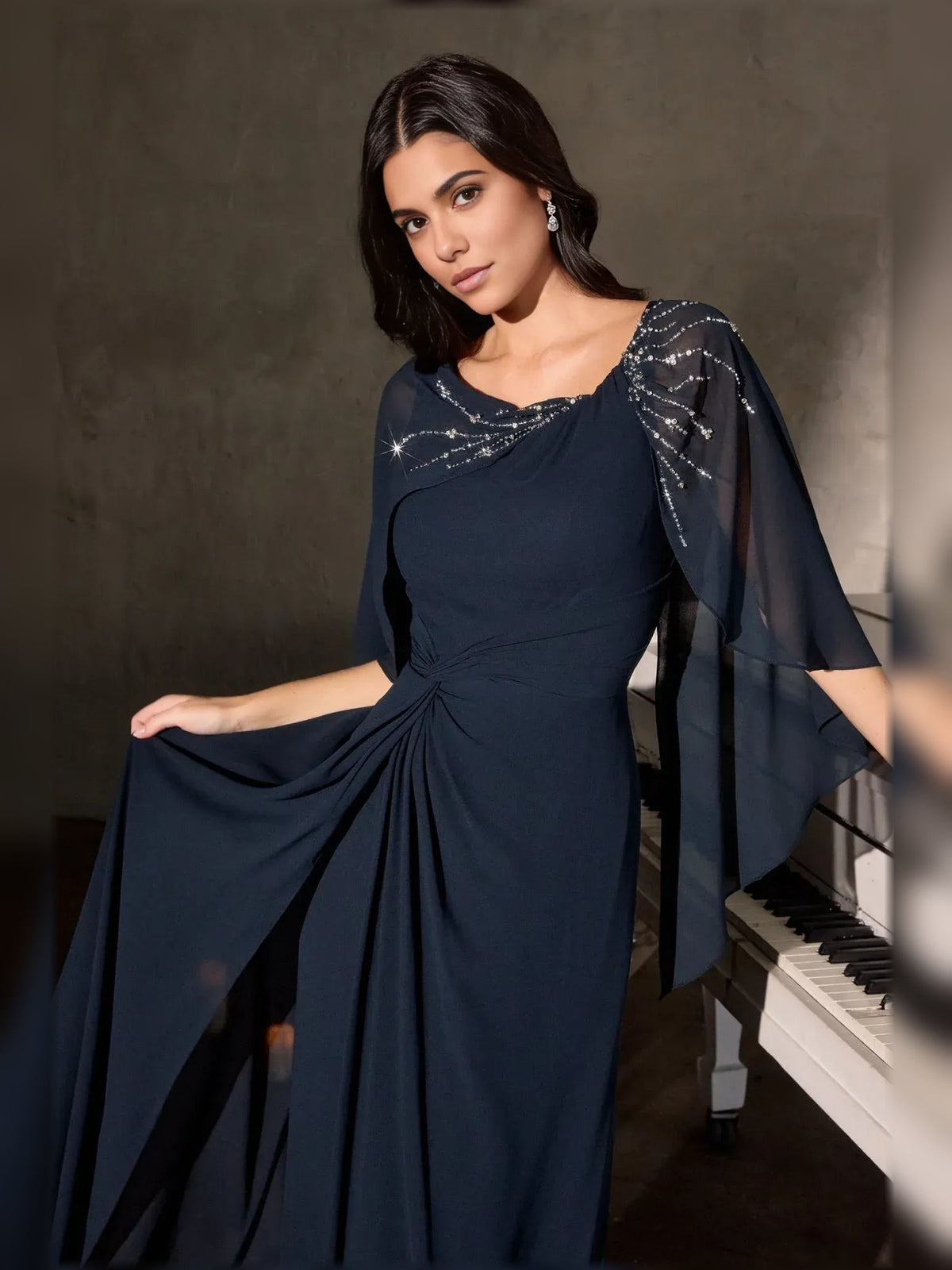 Navy chiffon scoop-neck gown with ruched waist and beaded sheer shoulder cape