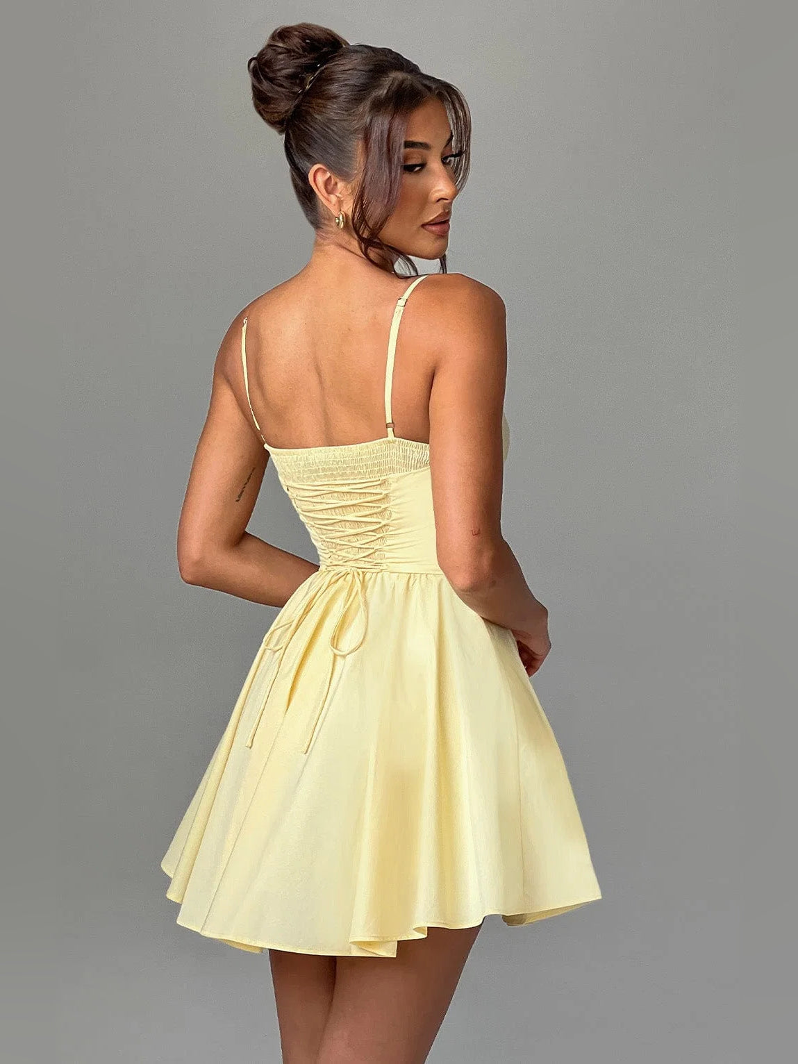Lemon mini dress back view with spaghetti straps and pleated A-line skirt