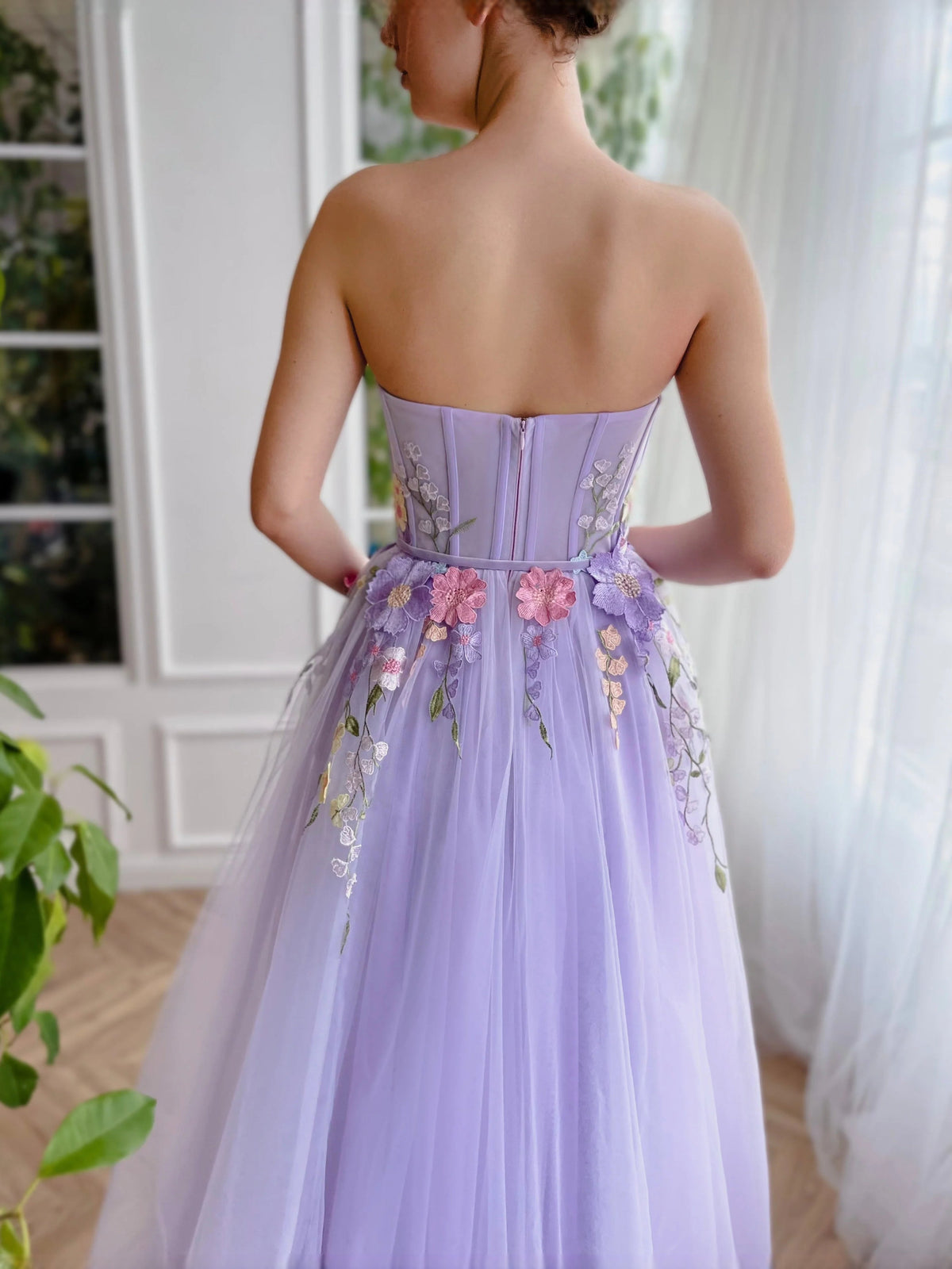 Lavender corset prom dress with floral applique and open back, flowing tulle skirt
