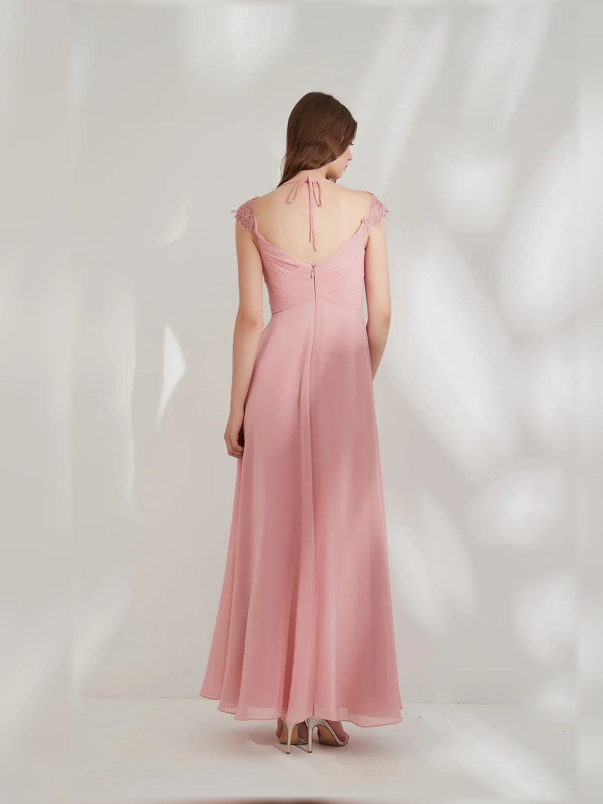 Back view of peach V-neck ruching A-line formal maxi dress with cap sleeves