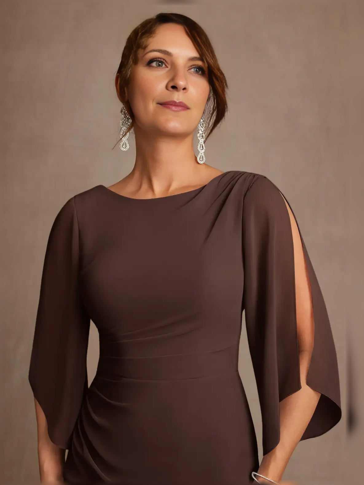 Chocolate draped boat-neck A-line gown with sheer cape sleeves, close-up front