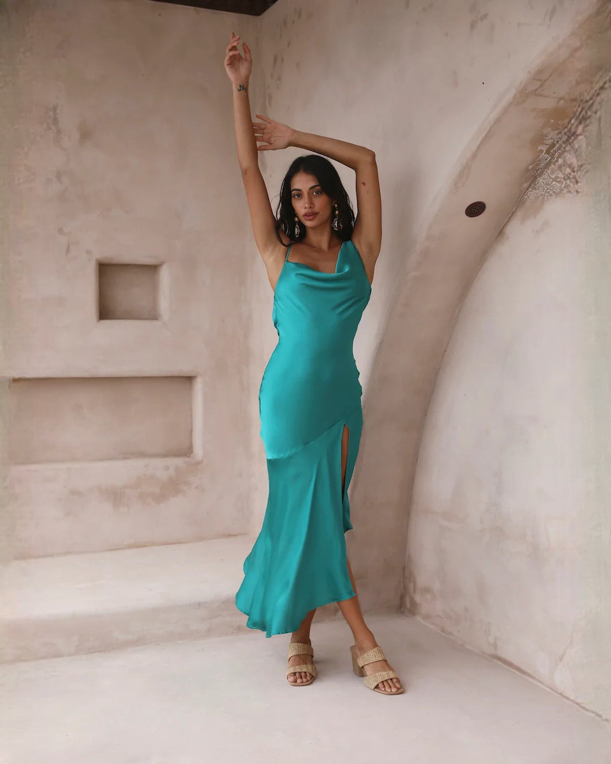 Teal satin sleeveless A-line midi dress with cowl neckline and fitted side-slit hem.