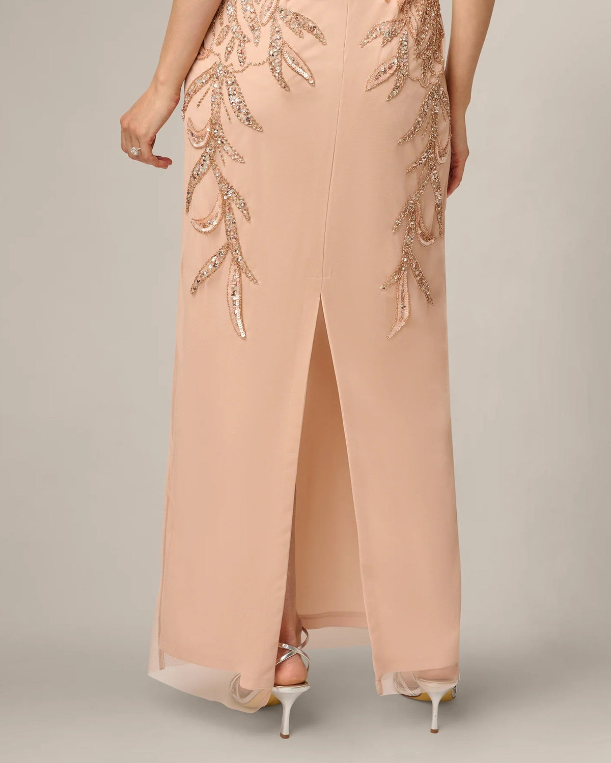 Rose gold sleeveless maxi sheath dress with beaded motif and thigh-high front slit