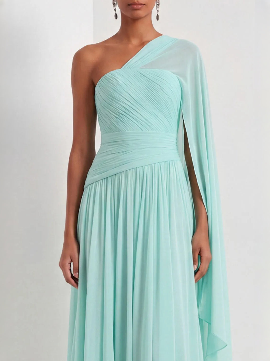 Mint green one-shoulder chiffon maxi dress with ruched bodice and flowing draped sleeve.