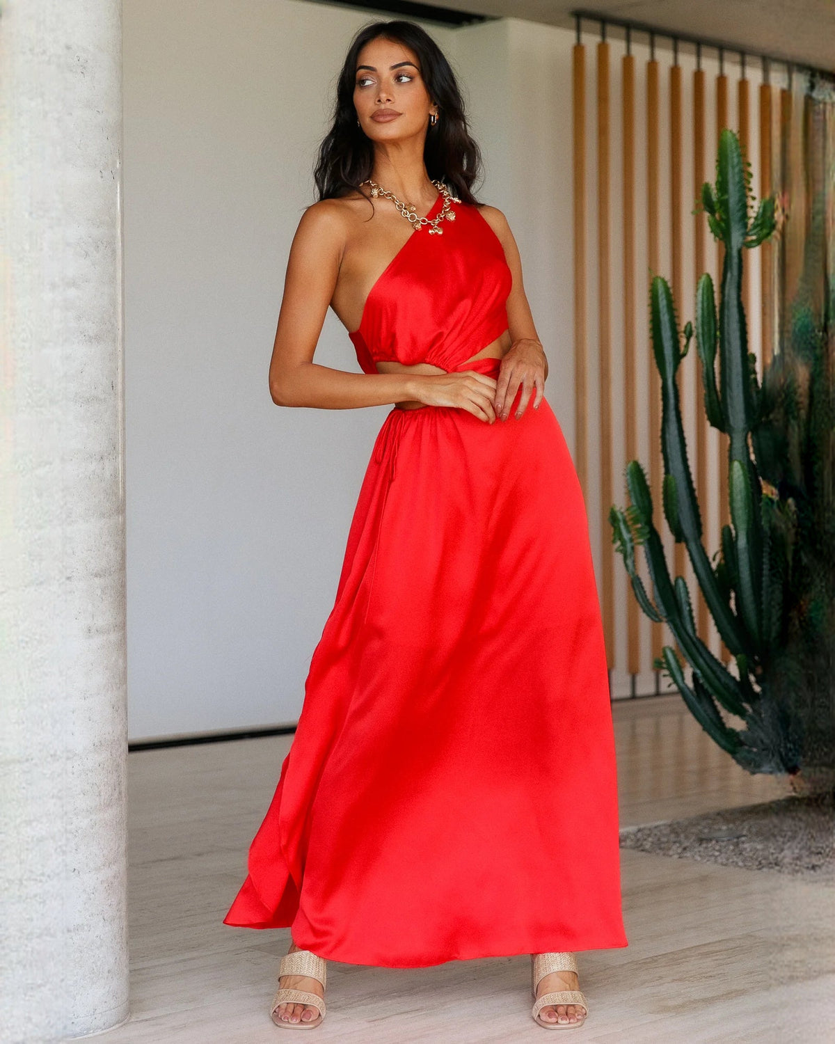 Red satin sleeveless A-line maxi bridesmaid dress with draped waist knot and open skirt.