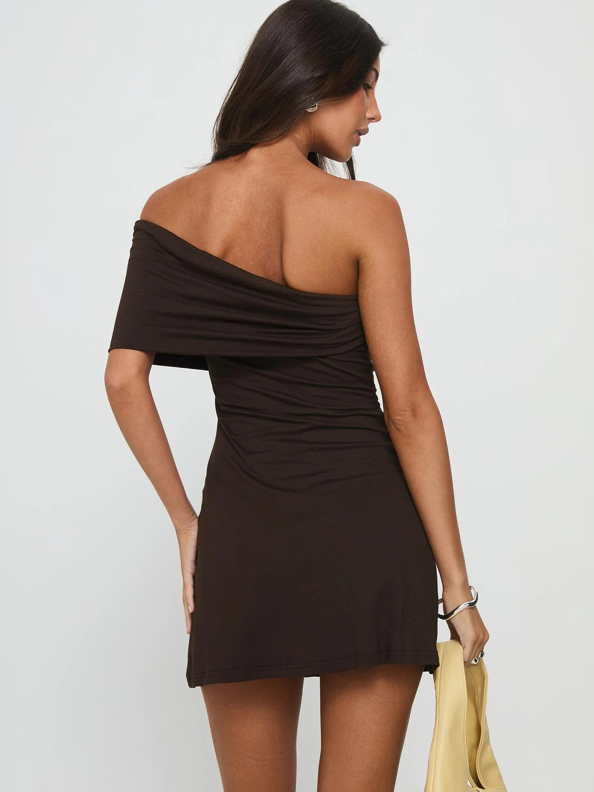 Chocolate one-shoulder mini dress with draped neckline, open-back style
