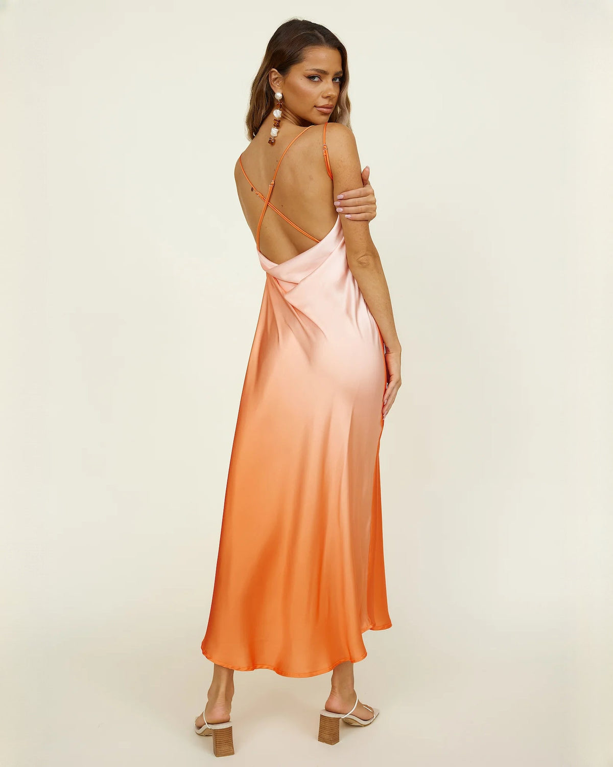 Peach orange satin A-line maxi dress with open back and thin crisscross straps